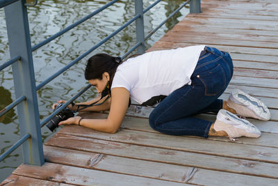 High angle view of woman sitting on staircase