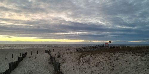 Scenic view of beach against sky during sunset