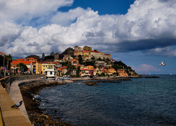 Townscape by sea against sky in town