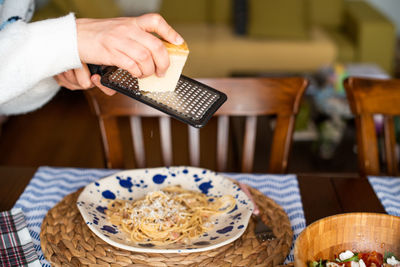 Close-up of hand holding food on table