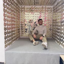 Full length of young man sitting against wall