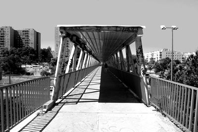 Bridge over river with buildings in background