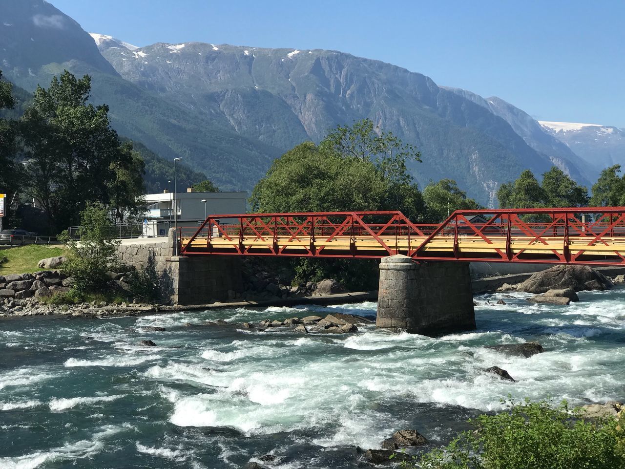 mountain, water, mountain range, nature, beauty in nature, built structure, architecture, bridge, day, bridge - man made structure, river, sky, plant, scenics - nature, connection, flowing water, no people, tree, motion, outdoors, flowing