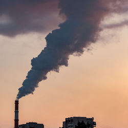 Low angle view of buildings against sky during sunset