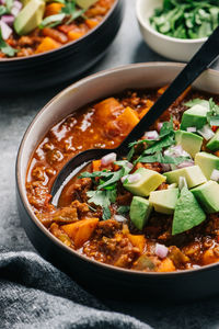 Paleo chili con carne closeup with fresh avocado