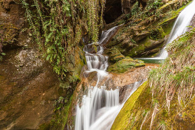 Beautiful waterfalls in caves carved out of sandstone, grotte del caglieron, veneto, italy