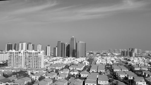 Aerial view of modern buildings in city against sky