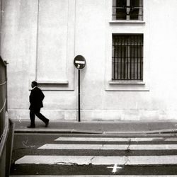 Full length of woman standing in front of building