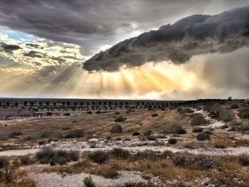 Scenic view of landscape against cloudy sky