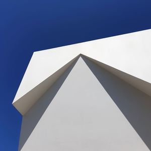 Low angle view of building against clear blue sky