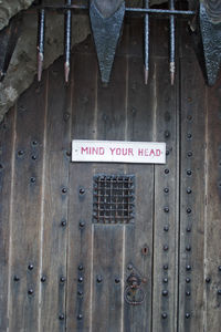 Close-up of text on wooden door