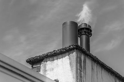 Low angle view of smoke stack against sky