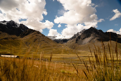 Scenic view of field and mountains against sky