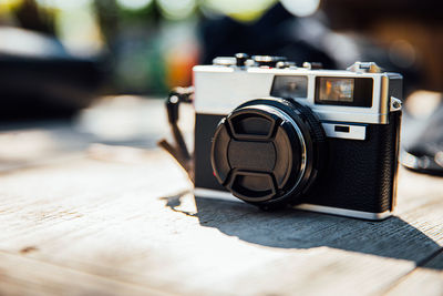 Vintage old photo film camera on wooden table