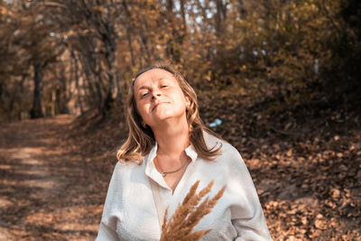 Portrait of smiling young woman in autumn