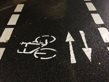 High angle view of arrow sign on road in city