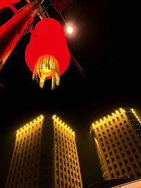 Low angle view of illuminated lanterns hanging in building at night