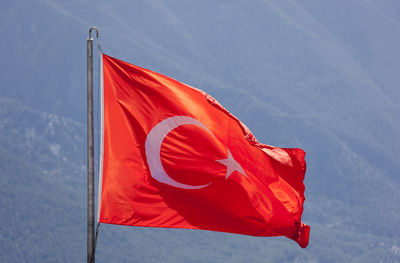 Low angle view of flag against the sky