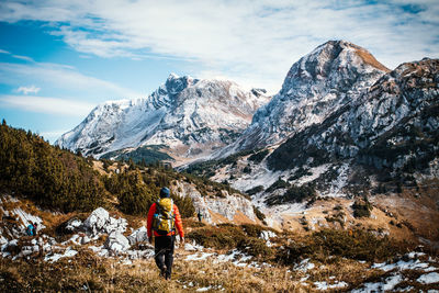 Full length of person on snowcapped mountains against sky