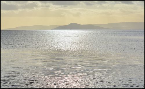 Scenic view of sea against sky at sunset