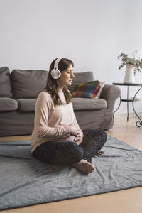 Woman sitting on sofa at home