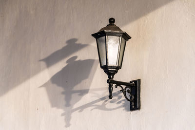 Close-up of street light mounted on wall
