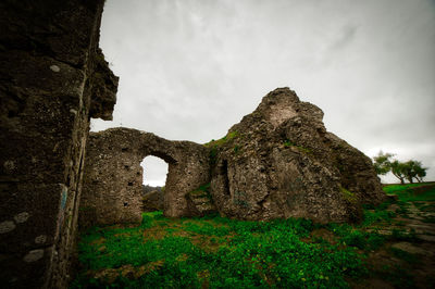 Low angle view of old ruins against sky