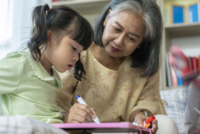 Close-up of a young woman reading book