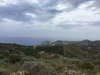 View of cityscape against cloudy sky