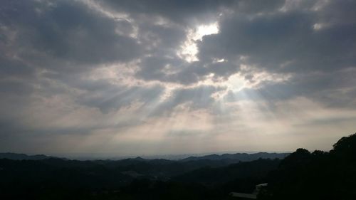 Scenic view of mountains against cloudy sky