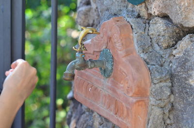 Statue of human hand against stone wall
