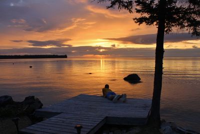 Scenic view of lake against sky during sunset