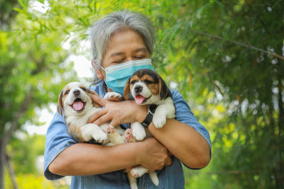 Portrait of woman with dog in park