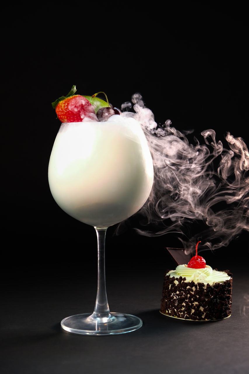 CLOSE-UP OF DESSERT AGAINST BLACK BACKGROUND