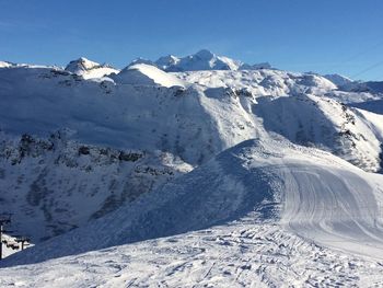 Scenic view of snowcapped mountains against clear sky