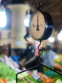 Close-up of weight scale hanging in market