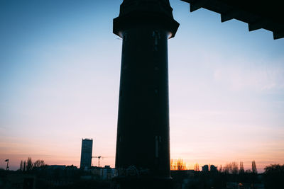 Low angle view of built structure against sky at sunset