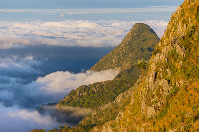 Scenic view of mountains against cloudy sky