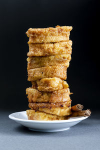 Easter dessert.traditional homemade spanish french toast on dark background in vertical format.