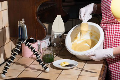 Woman cooking spinach muffins step by step, mixing ingredients with spatula