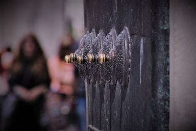 Close-up of hand holding metal door