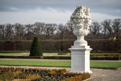 Statue in park against sky