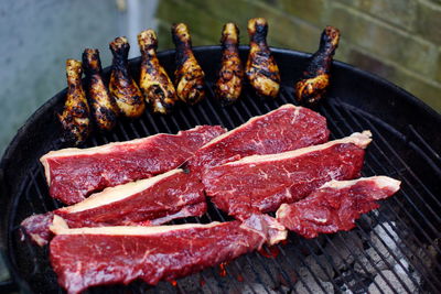 High angle view of meat on barbecue grill