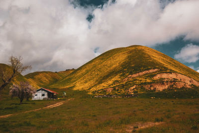 Scenic view of land and mountains against sky