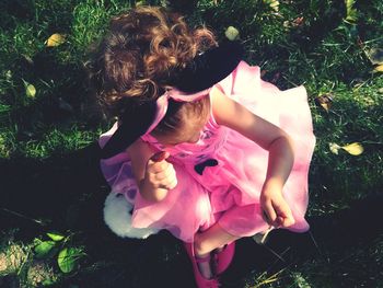 Cute girl sitting on field