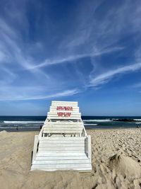 Lifeguard hut on beach against sky