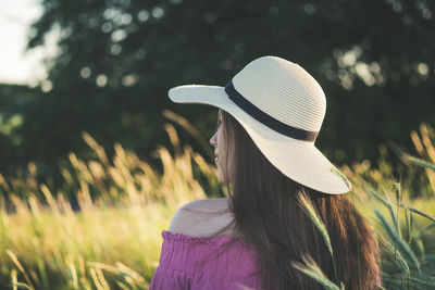 Portrait of woman wearing hat standing on land