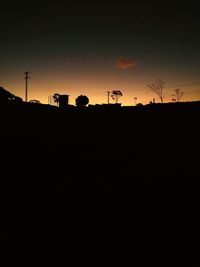 Silhouette landscape against clear sky during sunset