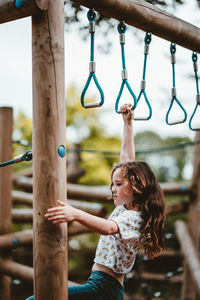 Full length of woman holding slide in playground