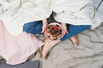 High angle view of baby relaxing on bed at home